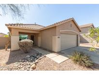 Charming single-story home with desert landscaping, neutral paint, and a tiled roof, plus a two car garage at 3911 W Desert Hollow Dr, Phoenix, AZ 85083