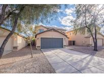 Charming two-story home featuring desert landscaping and a spacious driveway leading to a gray garage door at 3917 E Morenci Rd, San Tan Valley, AZ 85143