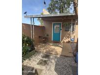 This covered patio features a cozy sitting area, garden and cheerful blue door at 4537 N 26Th Dr, Phoenix, AZ 85017