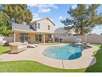 Inviting backyard with a pool, lounge area, outdoor dining, and lush landscaping perfect for entertaining at 5047 W Chicago S Cir, Chandler, AZ 85226