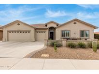 Charming single-story home with a three-car garage and a cozy front patio with desert landscaping at 11123 E Olla Ave, Mesa, AZ 85212