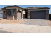 Beautiful single Gathering home featuring a brick exterior and a two-car garage at 1254 E Penedes Dr, Gilbert, AZ 85298