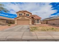 Two-story tan stucco home with a tile roof, two-car garage, and desert landscaping at 12574 W Desert Rose Rd, Avondale, AZ 85392
