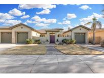 Inviting single-story home with well-manicured lawn and attached three-car garage at 14527 W Sheridan St, Goodyear, AZ 85395