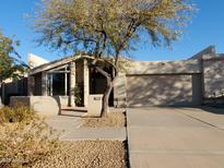 Charming single-story home with desert landscaping and a two-car garage at 1606 E Cactus Wren Dr, Phoenix, AZ 85020