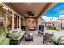 Spacious covered patio with ceiling fan, barbeque, seating and clear views of the lovely gazebo at 17938 W Cedarwood Ln, Goodyear, AZ 85338