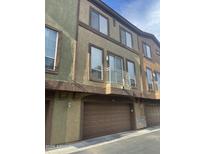 Townhouse exterior view featuring a balcony, garage, and stucco facade at 1920 E Bell Rd # 1188, Phoenix, AZ 85022