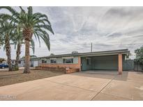 Charming single story home with mature trees and a covered carport at 2333 E Larkspur Dr, Phoenix, AZ 85022