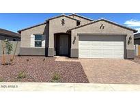Charming single-story home with a two-car garage and desert landscaping at 24598 W Grenadine Rd, Buckeye, AZ 85326