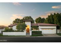 Charming exterior featuring a well-manicured lawn, classic architecture, and a tile roof at 3140 E Claremont Ave, Phoenix, AZ 85016