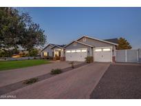 Charming single-Gathering home boasts a spacious driveway and a well-manicured front lawn at dusk at 3401 N 34Th Pl, Phoenix, AZ 85018