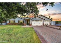 Charming single-Gathering home with a well-manicured lawn, a brick driveway, and a three-car garage at 3401 N 34Th Pl, Phoenix, AZ 85018