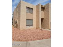 Two-story stucco condo featuring well-maintained landscaping with desert rock, in a vibrant community at 3526 W Dunlap Ave # 161, Phoenix, AZ 85051