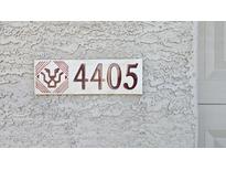 Close-up of the house number '4405' on a stucco wall with a decorative, modern sign at 4405 W Park St, Laveen, AZ 85339