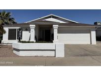 Charming single-story home with a well-maintained front yard and a two-car garage at 518 W Beverly Ln, Phoenix, AZ 85023