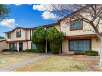 Inviting two-story townhome with a well-maintained lawn and mature landscaping, offering curb appeal at 6018 N 30Th Ave, Phoenix, AZ 85017