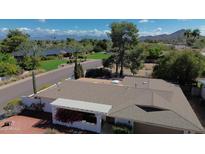 Scenic aerial view of a well-maintained home with a desert landscape and mountain views in the background at 9059 N Arroya Grande Dr, Phoenix, AZ 85028