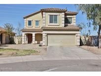 Charming two-story home featuring a two-car garage and well-maintained front yard at 10022 W Luxton Ln, Tolleson, AZ 85353