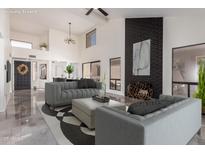 Bright and airy living room with high ceilings, sleek fireplace, and stylish furnishings at 10056 E San Bernardo Dr, Scottsdale, AZ 85258