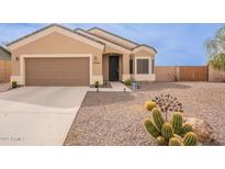 Charming single-story home featuring a desert landscape, neutral tones, and a two car garage at 10545 W Mission Dr, Arizona City, AZ 85123