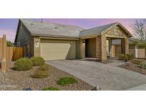 Charming single-story home with a two-car garage and a beautifully paved driveway complemented by desert landscaping at 13218 W Crimson Ter, Peoria, AZ 85383