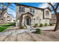 Charming two-story home featuring a stone-accented entryway and well-maintained landscaping at 1347 S Sabino Dr, Gilbert, AZ 85296
