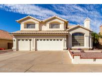 Inviting two-story home with a three-car garage and well-maintained landscaping in a suburban neighborhood at 1478 E Spur Ave, Gilbert, AZ 85296
