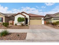 Charming single-story home featuring a tile roof, a two-car garage, and a low-maintenance landscaped yard at 23150 E Thornton Rd, Queen Creek, AZ 85142