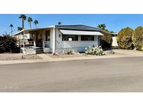 Charming single-story home with covered awning, desert landscaping, and a well-maintained yard at 305 S Val Vista Dr # 169, Mesa, AZ 85204