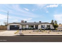 Charming single-story home featuring a well-maintained front yard and a two car garage at 3141 E Hillery Dr, Phoenix, AZ 85032