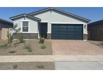 Charming single-story home with a two-car garage and desert landscaping in front at 3732 S 87Th Dr, Tolleson, AZ 85353