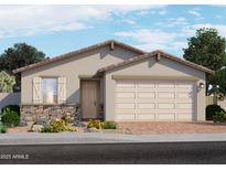 Charming single-story home featuring a two-car garage, stone accents, and a well-manicured front yard at 3814 S 87Th Dr, Tolleson, AZ 85353