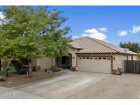 Charming single-story home featuring a well-manicured yard and a spacious two-car garage at 5932 W Poinsettia Dr, Glendale, AZ 85304
