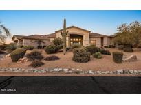 Stunning Southwestern-style home with desert landscaping, a cactus, and inviting curb appeal at 6240 E Ironwood Dr, Scottsdale, AZ 85266