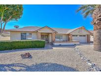 Charming single-story home with desert landscaping, brick accents, and a well-manicured front yard under a clear blue sky at 14617 W Windcrest Dr, Sun City West, AZ 85375