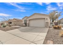 Charming single-story home featuring a two-car garage, stone accents, and a well-maintained desert landscape at 2213 E Constance Way, Phoenix, AZ 85042