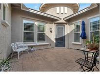 Inviting front patio with a decorative security door, white bench, and desert landscaping at 2254 E Tomahawk Dr, Gilbert, AZ 85298