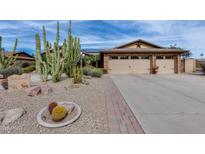 Charming home featuring low-maintenance desert landscaping, brick accents, and an attached two-car garage at 3302 W Renee Dr, Phoenix, AZ 85027