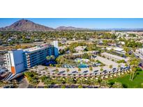 Stunning aerial view of a hotel surrounded by palm trees, landscaping, and desert mountains in Scottsdale, Arizona at 6850 E Main St # 4416, Scottsdale, AZ 85251