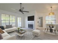 Bright living room featuring a modern fireplace, ceiling fan and a stylish grey patterned rug at 6885 E Cochise Rd # 219, Paradise Valley, AZ 85253