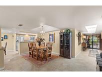 Open dining area featuring a wooden table, decorative rug, and a view into the kitchen at 8082 E Via Del Vencino --, Scottsdale, AZ 85258