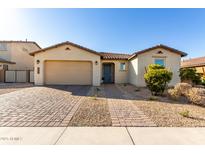 Charming single-story home featuring a two-car garage and low-maintenance desert landscaping at 10931 W Bloch Rd, Tolleson, AZ 85353