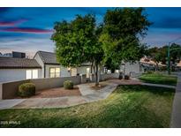 Charming home featuring lush landscaping, a private courtyard, and a welcoming walkway at 1180 E Belmont Ave, Phoenix, AZ 85020