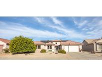 Charming single-story home featuring a red tile roof, desert landscaping, and a two-car garage at 15864 W Clearwater Way, Surprise, AZ 85374