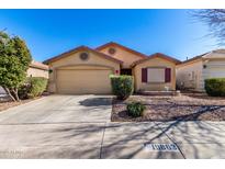 Charming single-story home featuring a well-manicured yard and attached two-car garage at 19863 N Emmerson Dr, Maricopa, AZ 85138