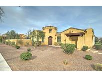 Inviting single-Gathering home featuring a rotunda entrance and desert landscaping at 20930 W Sunriise Ln, Buckeye, AZ 85396