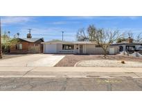 Charming single-story home with a well-maintained front yard and a long driveway at 2545 E Amelia Ave, Phoenix, AZ 85016