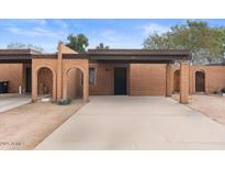 Charming single-story brick home with a covered entryway and well-maintained landscaping, with a private driveway at 331 S Beck Ave, Tempe, AZ 85281