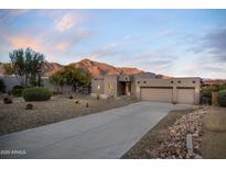 Beautiful desert home with a long driveway, two-car garage and mountain views at 4845 S Strike-It-Rich Dr, Gold Canyon, AZ 85118