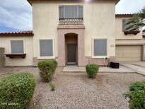 Two-story home featuring a desert landscape, tan stucco, and a red tiled roof at 671 E Colt Ct, Chandler, AZ 85225